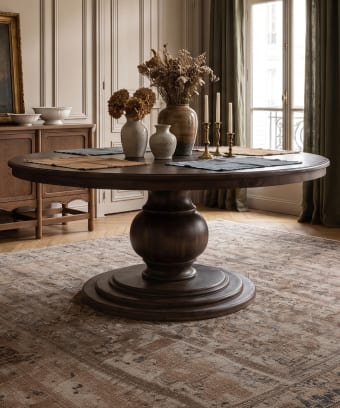 Round pedestal dining table in a collected dining room